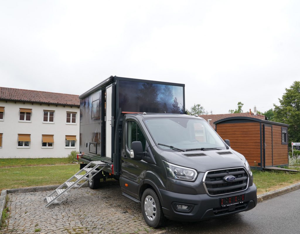 Absetzkabine mit Fahrzeug seitlich vorne mit Treppe